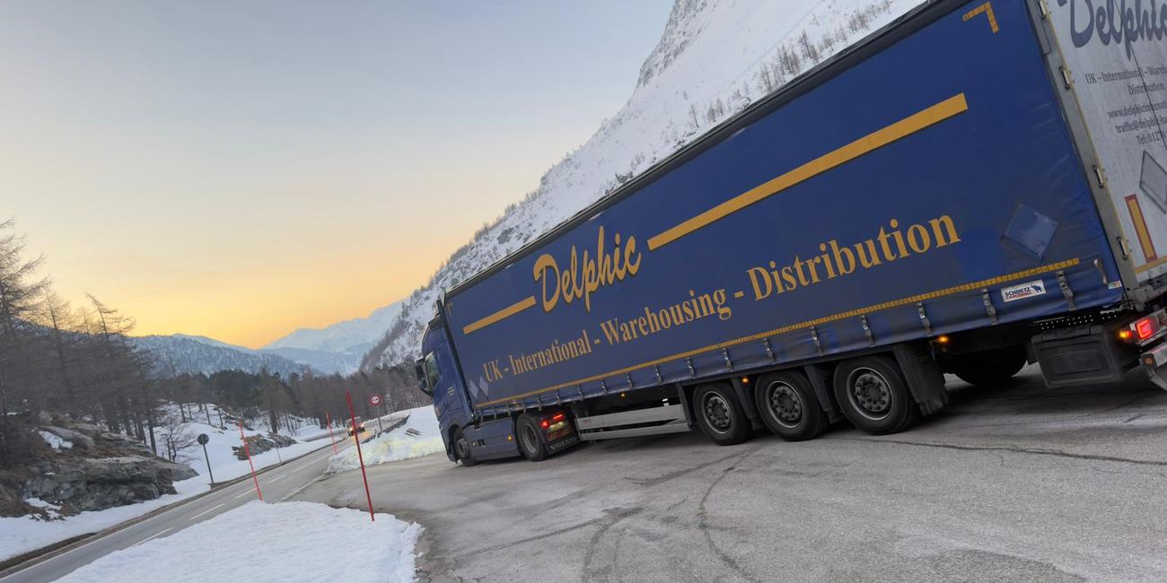 Delphic outfit on a snow-lined alpine pass at dusk