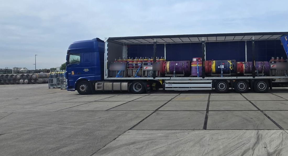Gas cylinders racked and strapped on a Delphic curtainsider under ADR