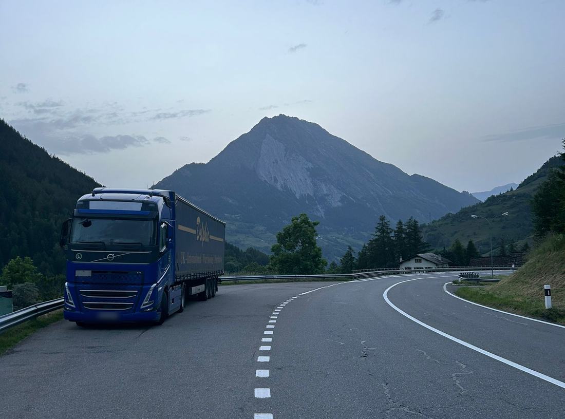 Delphic Volvo and curtainsider climbing an alpine road on the run to Italy