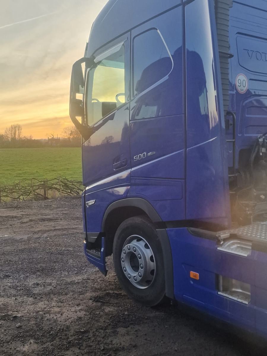 A Delphic cab at sunset beside Cheshire fields
