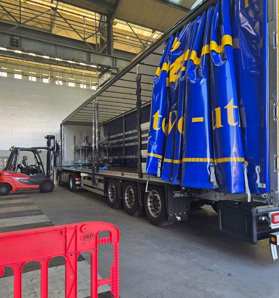 Forklift loading a Delphic curtainsider inside the warehouse at Winsford